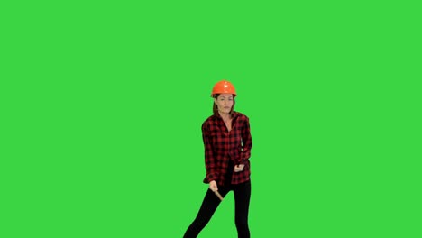 dancing female with a paint brush on a green screen, chroma key