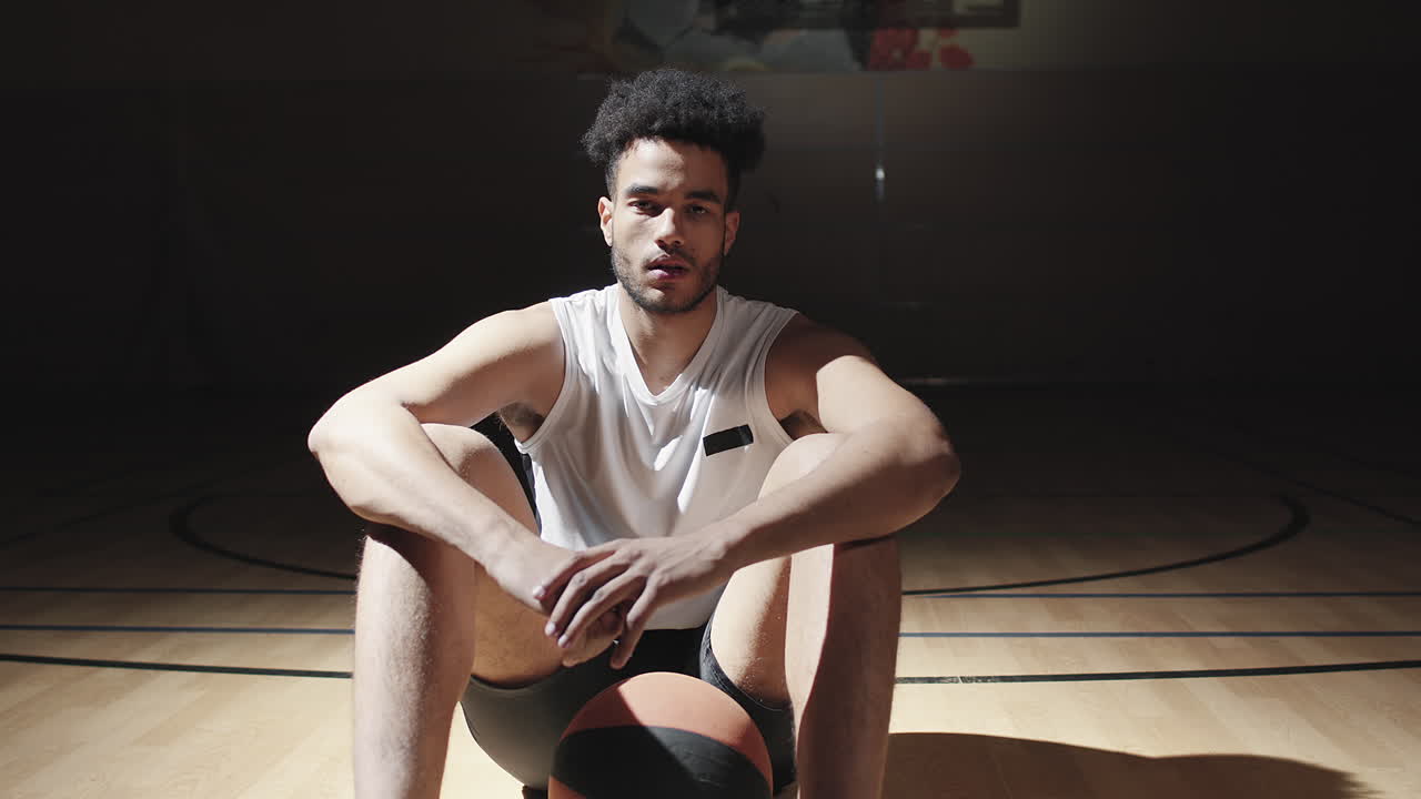 Portrait of Man Sitting on Basketball Court