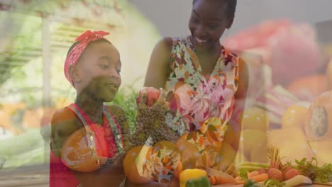 Composite-video-of-vegetables-against-african-american-mother-and-daughter-picking-vegetables