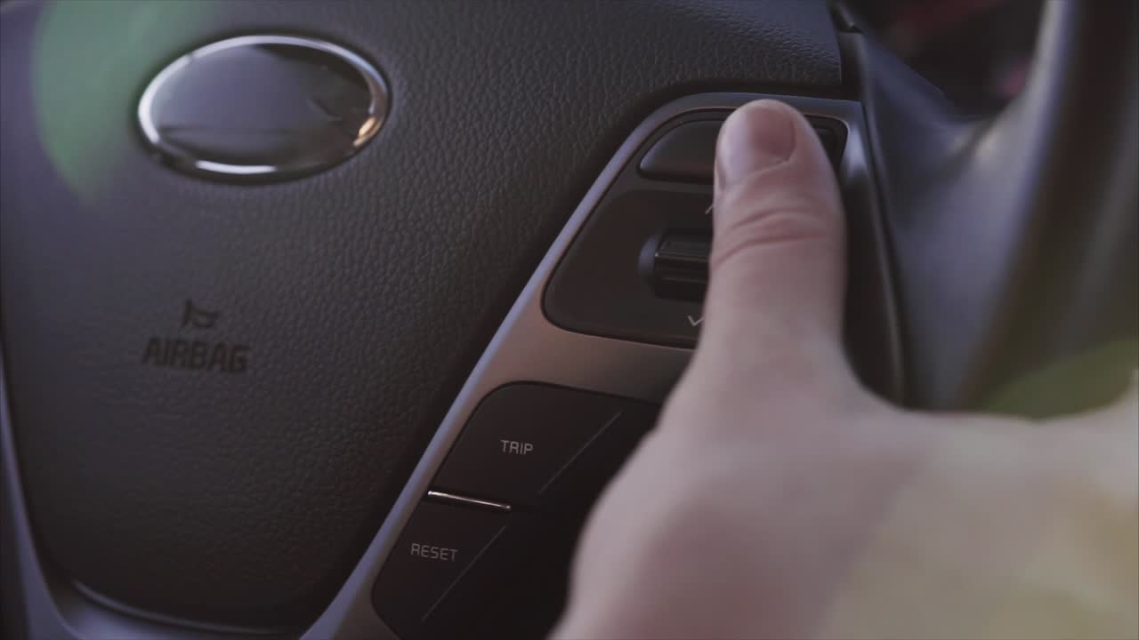Person Adjusting Car Steering Wheel Controls