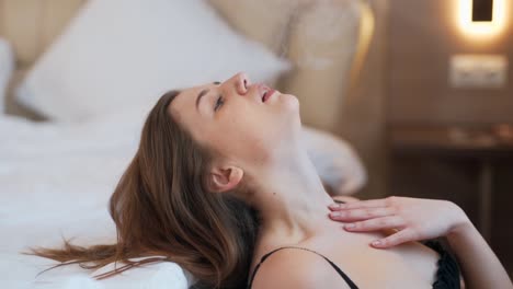 portrait of a woman in lingerie smoking an electronic cigarette in the bedroom