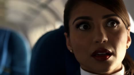 woman's shocked expression on an airplane