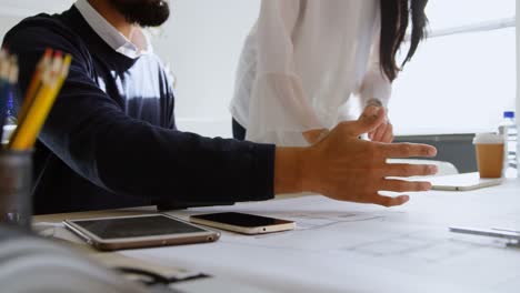 business colleagues interacting with each other in office 4k