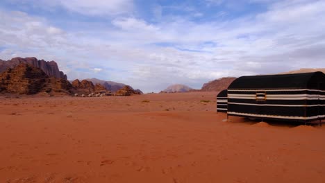 arabian bedouin tents for tourist accommodation in the vast, remote and mountainous desert of wadi rum in jordan, middle east