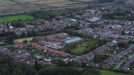 Aerial-view-pan-right-above-Halton-North-England-coastal-countryside-town-estate-green-space