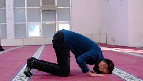 muslim man places his forehead on the ground