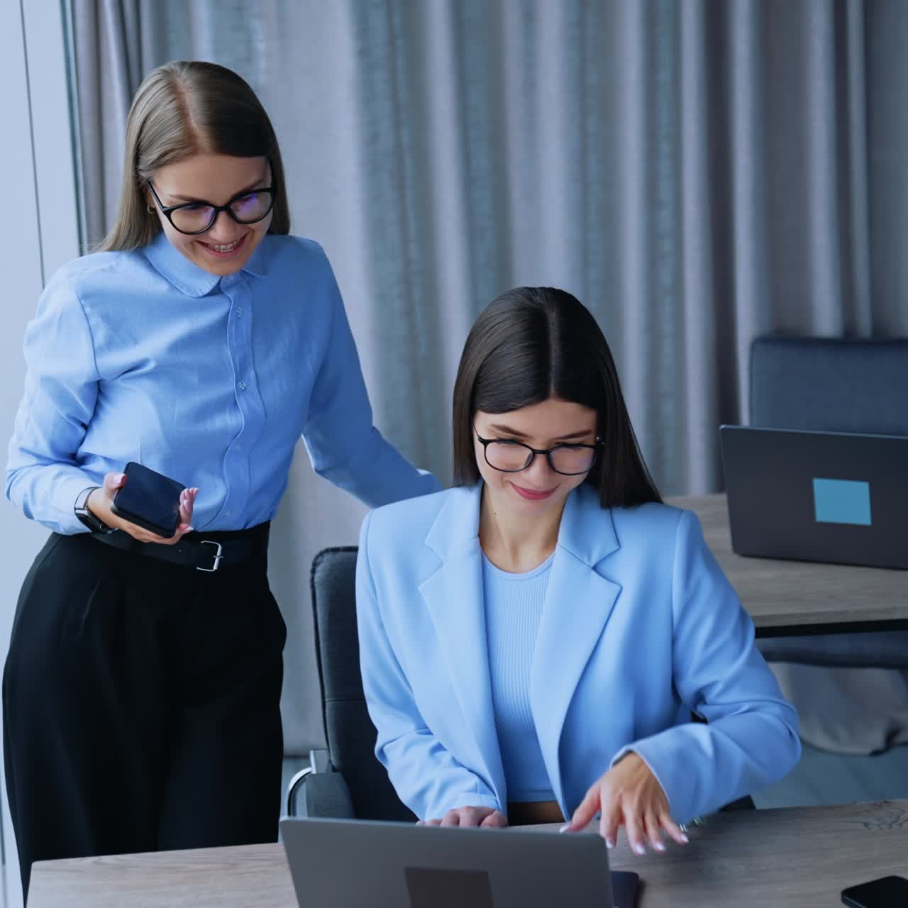 Female business managers working together. Young pretty lady office workers discussing