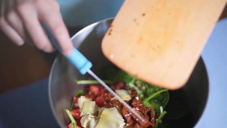 Slow-Motion:-Chopped-dried-mediterranean-tomatoes-being-pushed-from-a-cutting-board-into-a-bowl