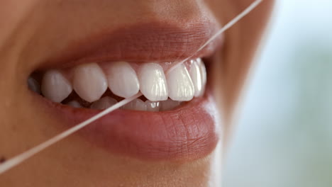 woman flossing her teeth