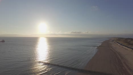aerial: the beach between vlissingen and dishoek during sunset