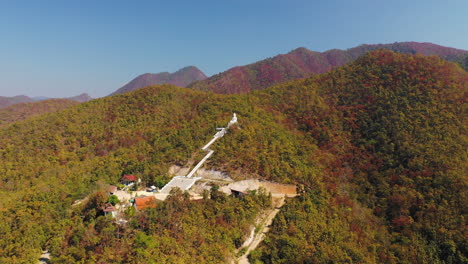 Aerial-view-of-a-Buddhist-temple-in-the-mountain-landscape-of-Pai,-Thailand