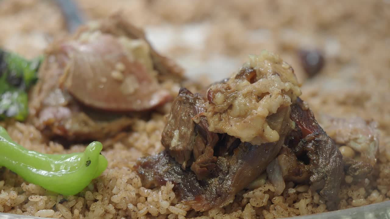 Close-up of a traditional Middle Eastern or South Asian meat and rice dish