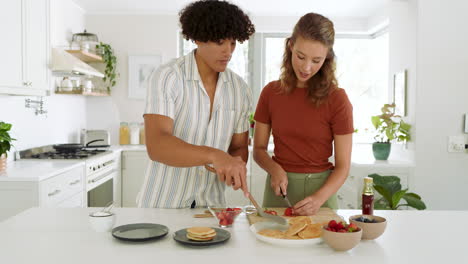 diverse couple preparing fresh fruit together in modern kitchen, enjoying cooking time, at home