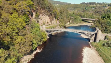 a listed cast iron craigellachie bridge on the river spey near the village of aberlour in moray