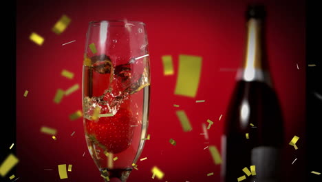strawberry in a glass of champagne and confetti