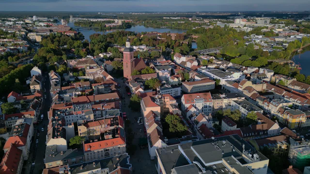 Berlin Spandau old town with its red rooftops, churches, and surrounding greenery. Lovely aerial view flight static tripod hovering drone