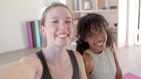 Portrait-of-happy-diverse-women-exercising-sitting-on-yoga-mats,-slow-motion