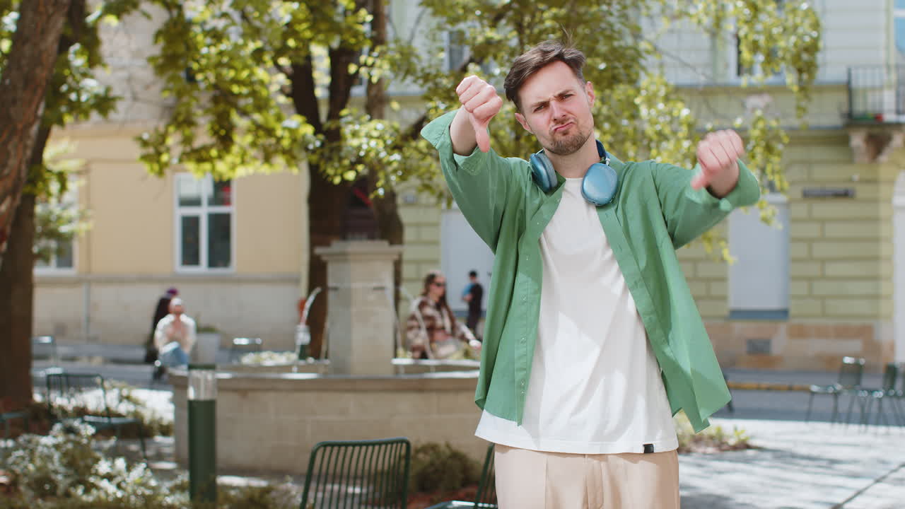 Man showing thumbs down sign dislike expressing discontent disapproval dissatisfied bad work mistake