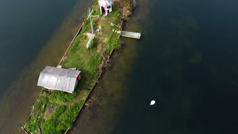 aerial drone shot of a small island surrounded by the water bay - drone shot of the islands