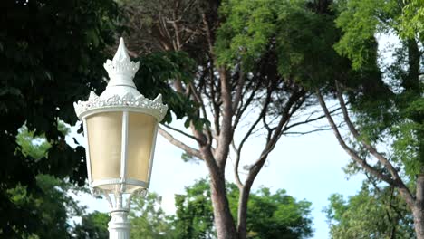 ornate white street lamp in a park