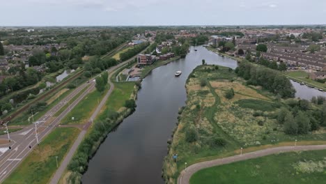 zoom in on an aerial view of a boat sailing above the road in the netherlands