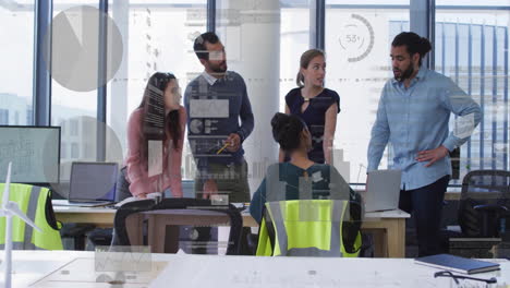 discussing data analytics with charts overlay, business team collaborating in office