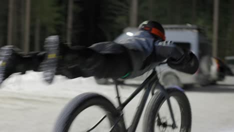 fatbike winter rider planks like superman on his bike goofing around fun