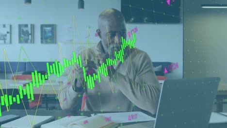 animation of statistical data processing on african american man taking notes using laptop at office