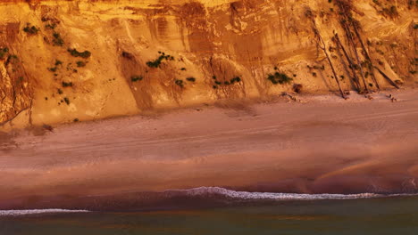 aerial drone revealing a shrinking beach along the steep banks of jurkalne, latvia. climate change playing a major role in the drastic environmental changes to the coastal landscape.