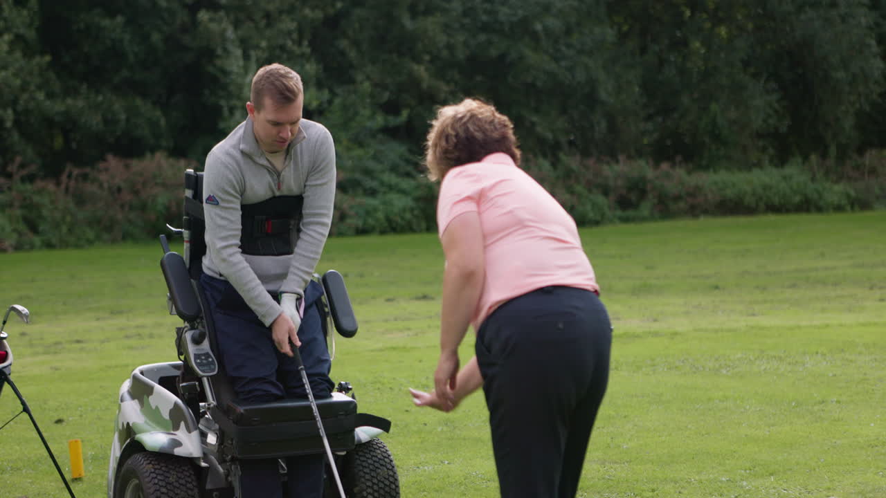 Man playing golf in a wheelchair
