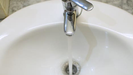 open tap in the sink with running water