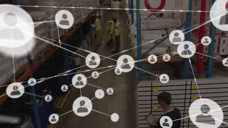 animation of connected icons over high angle view of african american worker walking in warehouse