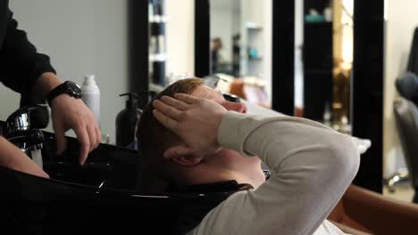 man getting a hair wash at a salon