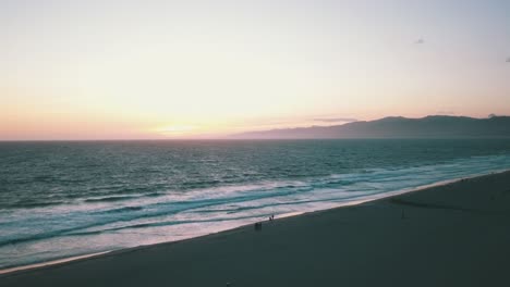drone shot of sunset over pacific ocean at venice beach los angeles