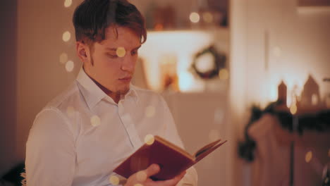 man reading story book at home during christmas