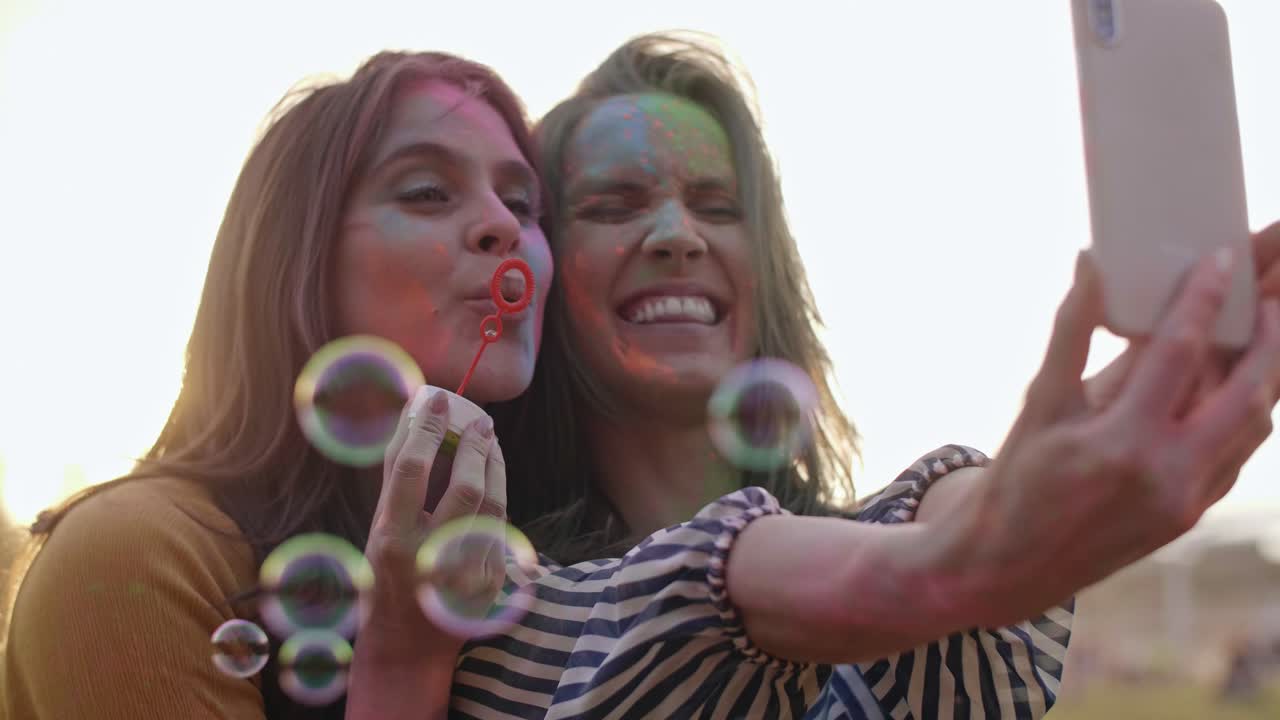 Colorful friends making selfie at music festival