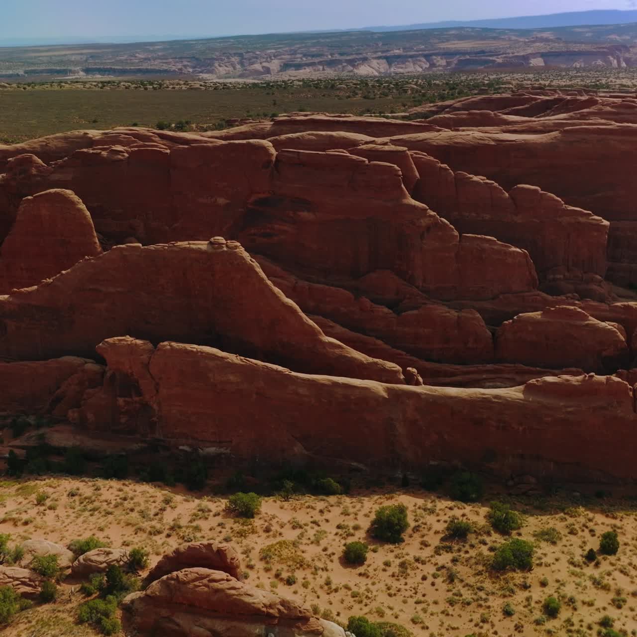 Oddly-shaped rocks grouped together in the sunlit landscape. National Park panorama in Utah from aerial perspective