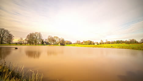 Winter-timelapse-capturing-the-reflection-of-blue-sky-clouds-on-a-lake