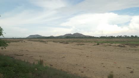 Long-stretch-of-sacred-Falgu-River-dry-waterbed-with-a-long-stretch-of-sand-dunes,-Bodhgaya,-Bihar,-India