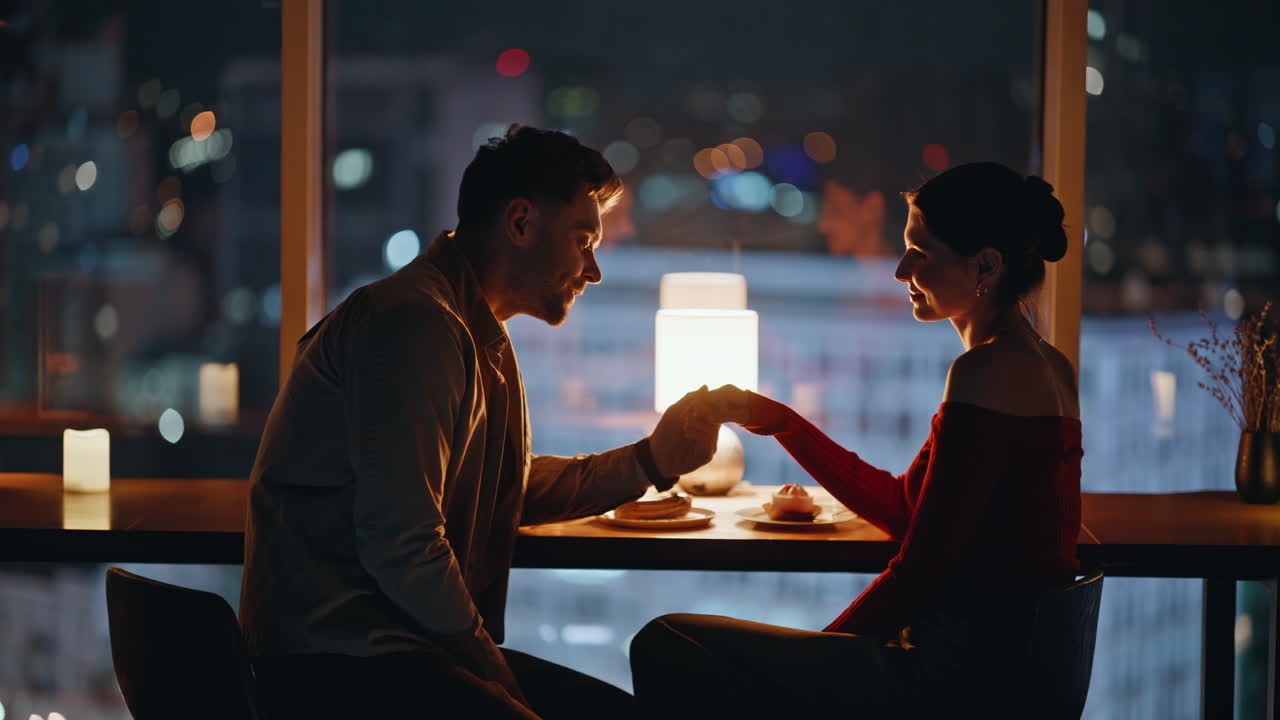 Couple Enjoying a Romantic Dinner Date with City View