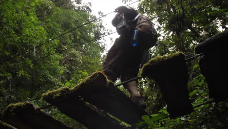 Old-Mossy-Bridge-Camera-Looking-Up-Tourist-Walks-over-in-Slow-Motion