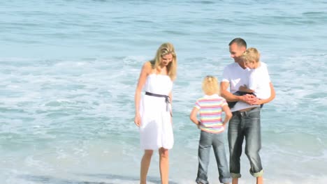 family walking in the sea