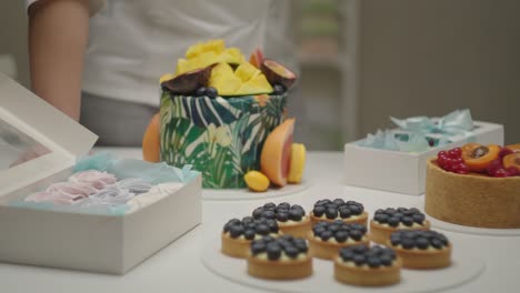 female hand paying for confectionery with nfc payment terminal using mobile phone in slow motion.