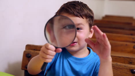 cute pupil holding magnifying glass