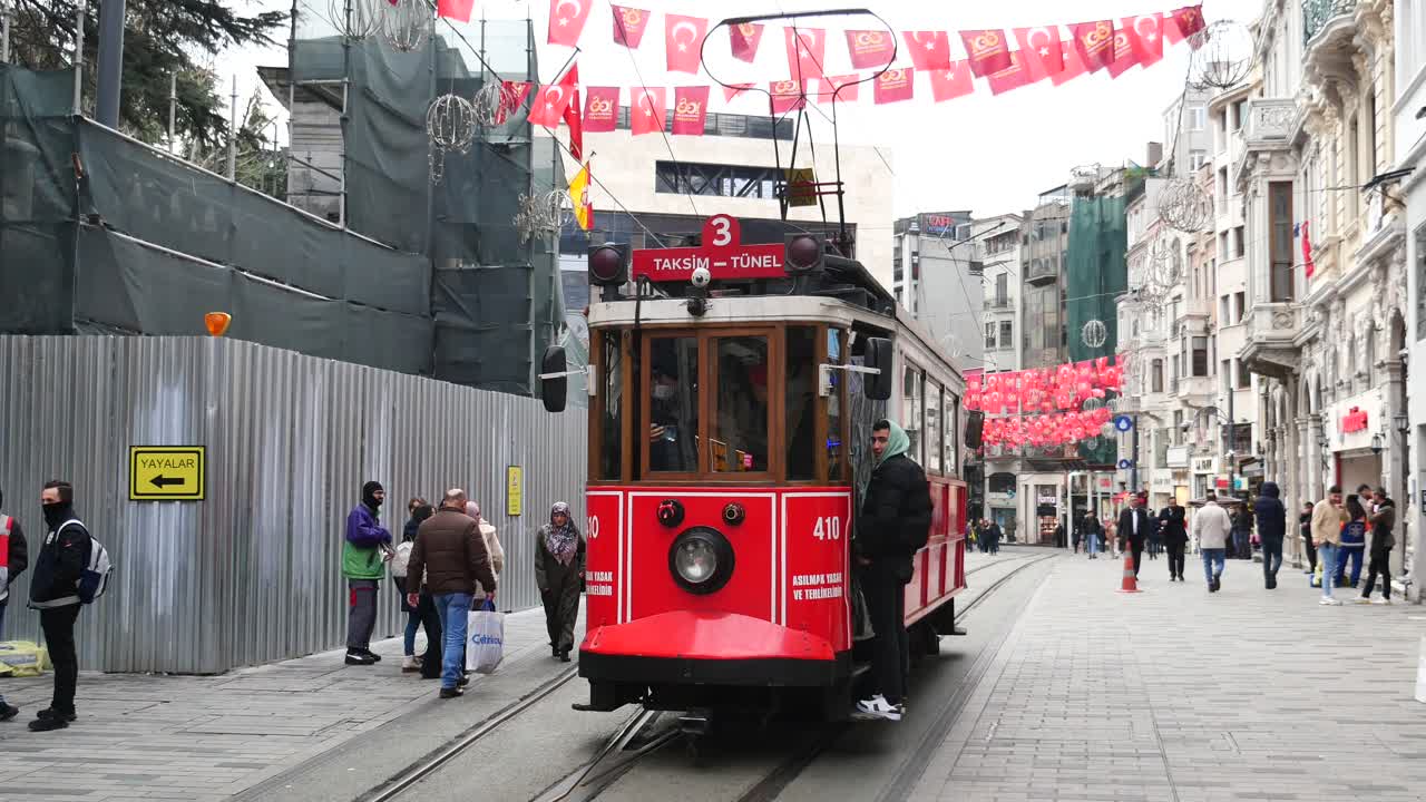 터키 이스탄불 한가운데에서 빨간색 트램을 타고 거리를 고 있는 사람들