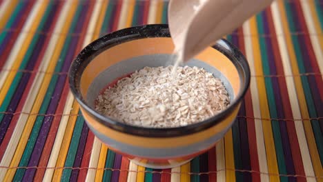 pouring oatmeal into a bowl