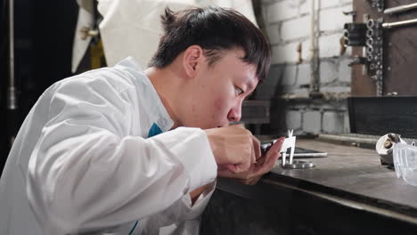 lab technician uses vernier caliper to measure metal object's diameter on workbench, taps tablet for data input, background features mechanical tools, brick wall, bright workspace lightings