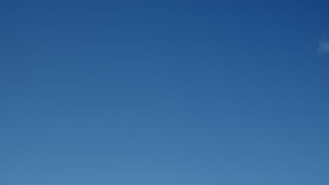 Time-lapse-of-white-clouds-moving-past-blue-sky