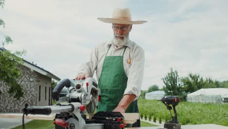 elderly carpenter working outdoors