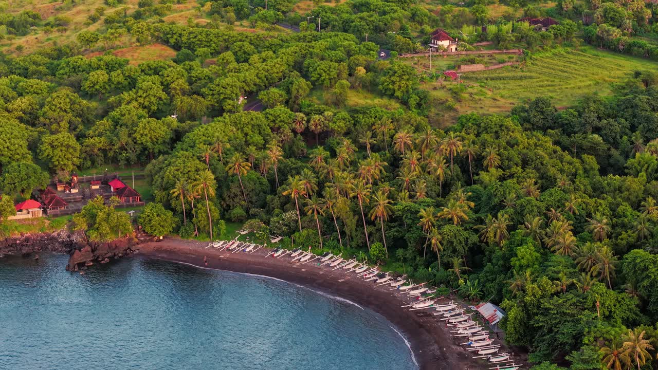 Aerial drone view of Tulamben bay with traditional jukung fishing boats on the beach